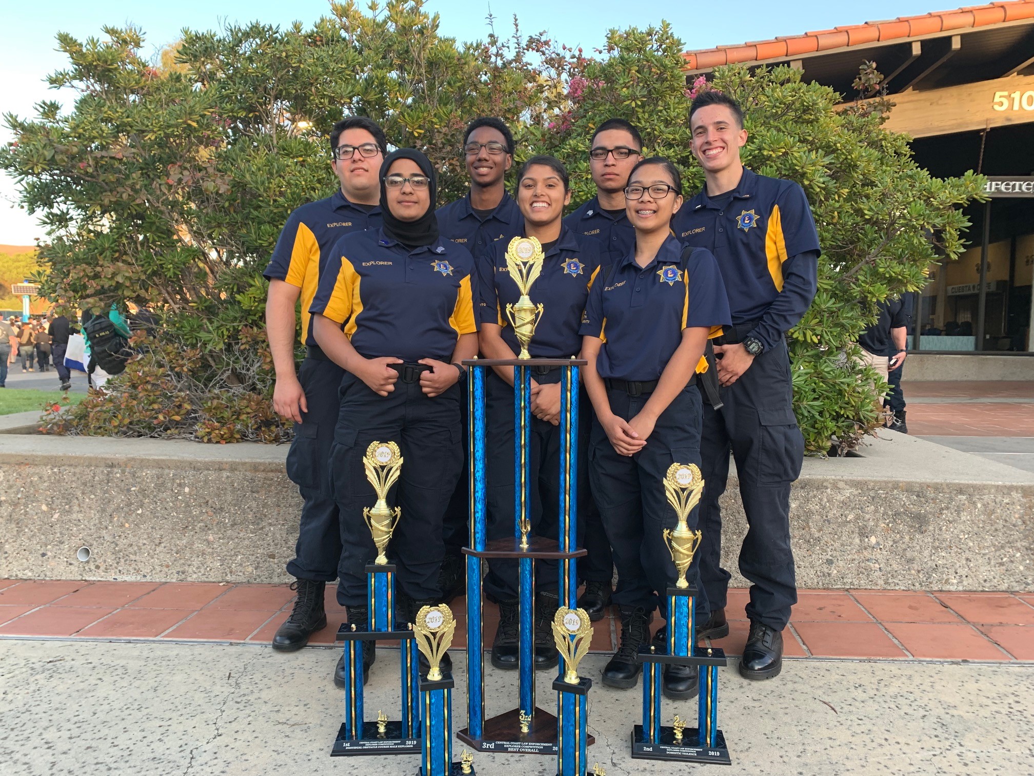 South Sacramento Explorers standing next to trophies